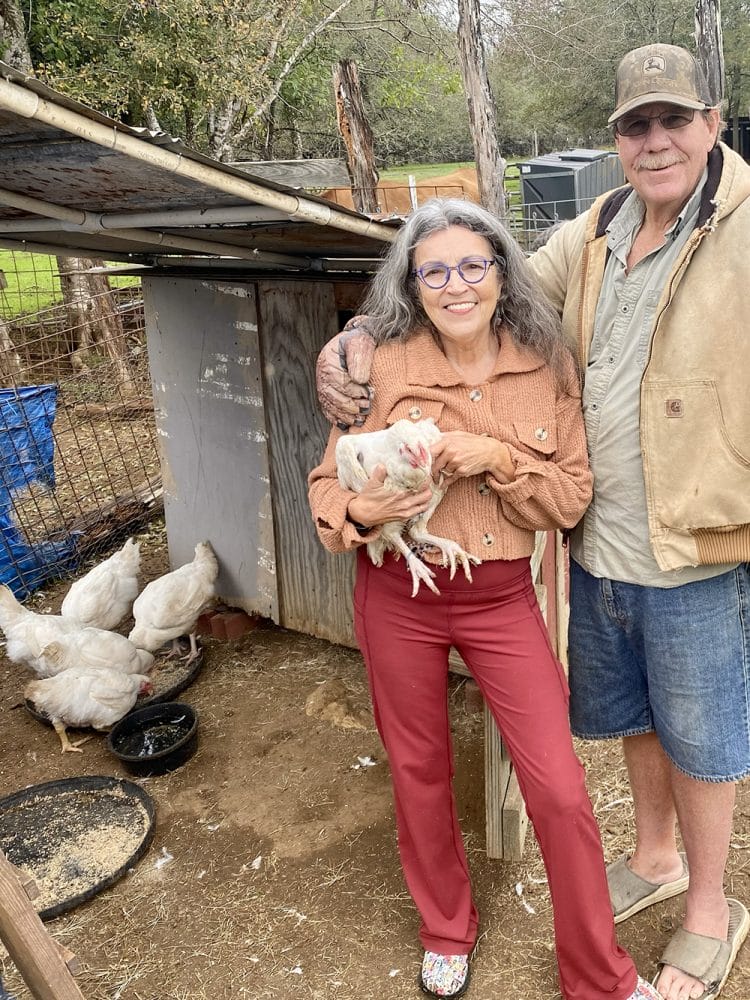Renee-and-Tommy-Cornish-Cross-2-scaled-1 Renee holding one of the new chickens on arrival.