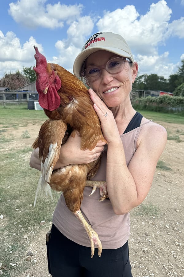 Malachi and Erin_1762 Malachi, one of the roosters at Rowdy Girl with Rowdy Girl Sanctuary supporter, Erin.