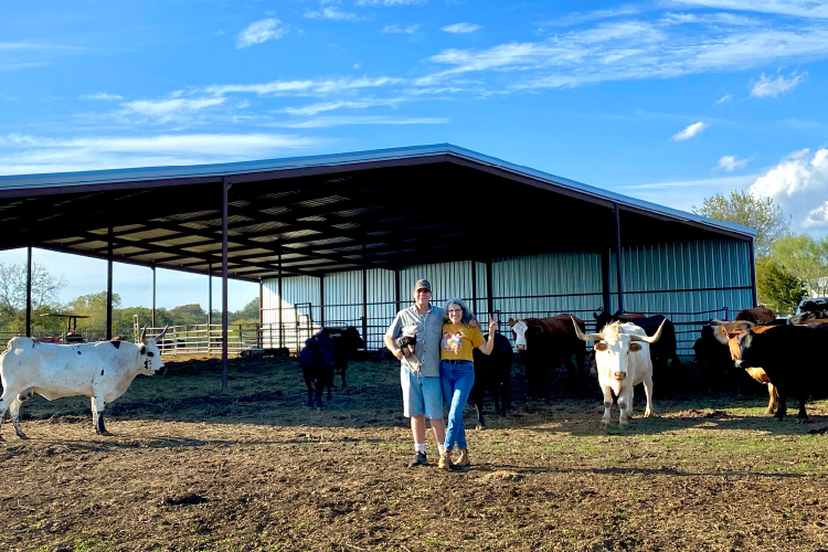Medical Treatment Facility Phase 1 Tommy and Renee standing in front of the Cow House