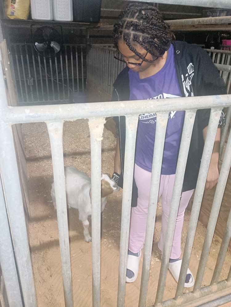 Symone standing with Sayter in pen