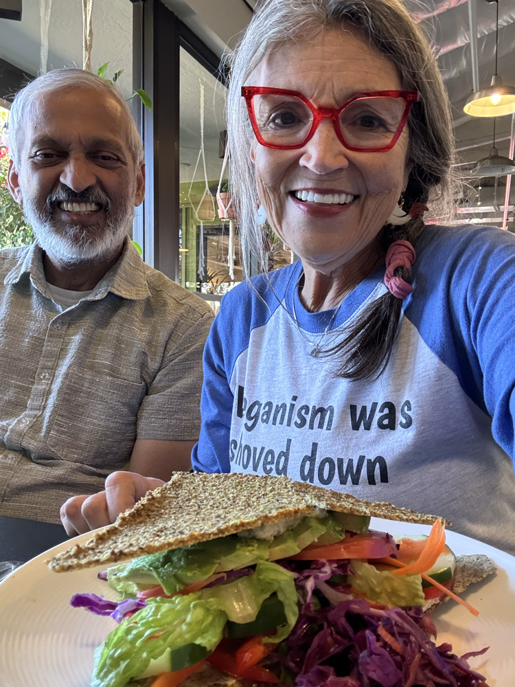 Renee with Dr Rao with plate of food